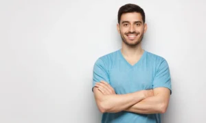 A smiling man with a confident, healthy smile representing the high value and long-term investment of the cost of teeth veneers for a complete smile transformation