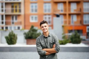 A young man smiling confidently after a successful method of treatment for dental pain, showcasing the relief and lifestyle freedom achieved through professional restorative care.