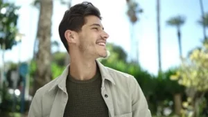 A young man showcasing a confident, natural smile, representing the successful results of dentists recommending cosmetic veneers for a subtle and professional dental transformation.