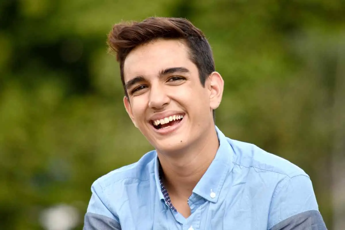 A smiling young man enjoying the outdoors, representing the joyful relief and peace of mind that comes after getting rid of a debilitating toothache through professional care