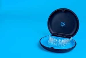 Black,Plastic,Case,With,Transparent,Braces,On,Blue,Background.,Insivible