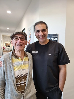 A man taking picture with Dr Sehmi