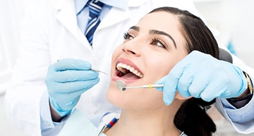 A female patient sitting comfortably in a dental chair during a professional general check-up, showcasing a positive and relaxed dental experience
