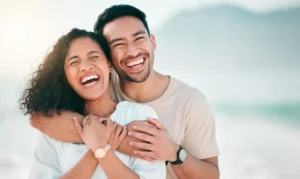A confident, healthy smile a joyful couple enjoys a sunny day at the beach