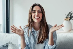 Patient showing off a confident smile while relaxing on a sofa