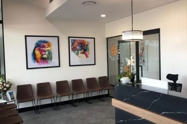 Modern waiting room with a row of brown chairs