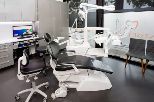Clinic treatment room featuring a professional dental chair wide angle