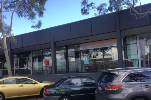 Cars are parked in front of Finesse Dental Clinic Side Angle