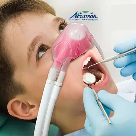 A child receiving comfortable pediatric dental care using IV sedation and sleep dentistry techniques, featuring a pink nitrous oxide mask to ensure a calm and pain-free experience