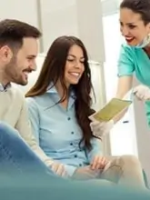 A couple consulting with a doctor regarding the treatment outcomes.