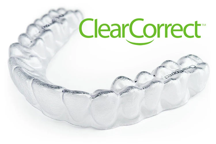 A clear aligner is shown with the "ClearCorrect" logo above it in green. The aligner is transparent and positioned in a U-shape, symbolizing dental alignment.