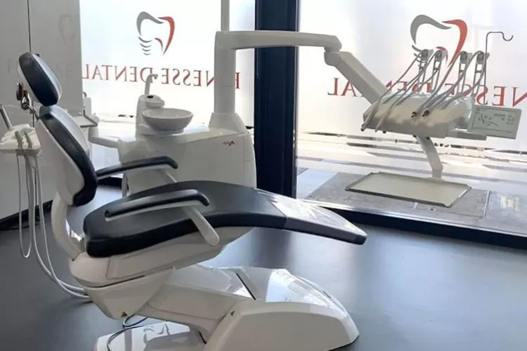 A view inside the Finesse Dental clinic, featuring a modern treatment room with a sleek black and white dental chair, state-of-the-art equipment, and a professional, sterile atmosphere designed for patient comfort