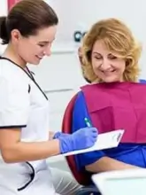 A staff member gathering patient information during a consultation